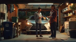 a cheerful american family stands next to their car in a well-lit urban garage, displaying confident smiles as they discuss the vehicle's maintenance, symbolizing the importance of professional transmission troubleshooting.